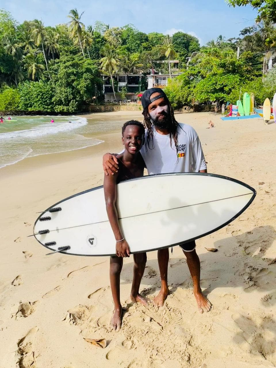 Instructor coaching a young surfer